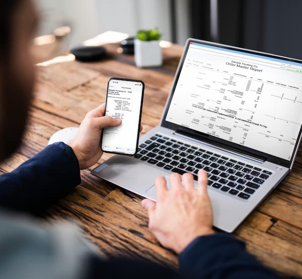 Person using a laptop and smartphone at the same time