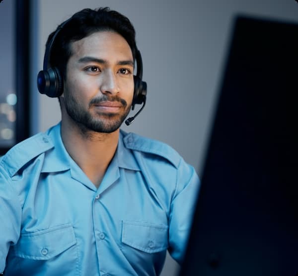 Man in front of a computer wearing headphones