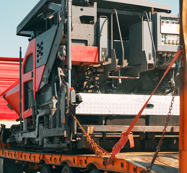 Heavy equipment on a truck bed