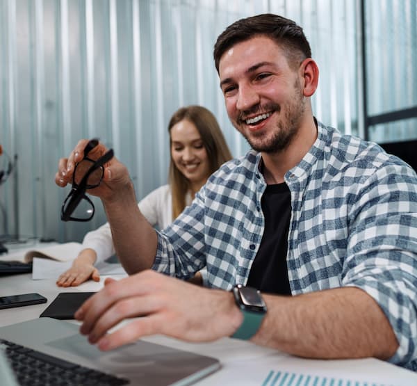Man and woman at a desk smiling