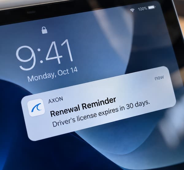 Tablet with a notification from the Axon app of a driver's license renewal reminder